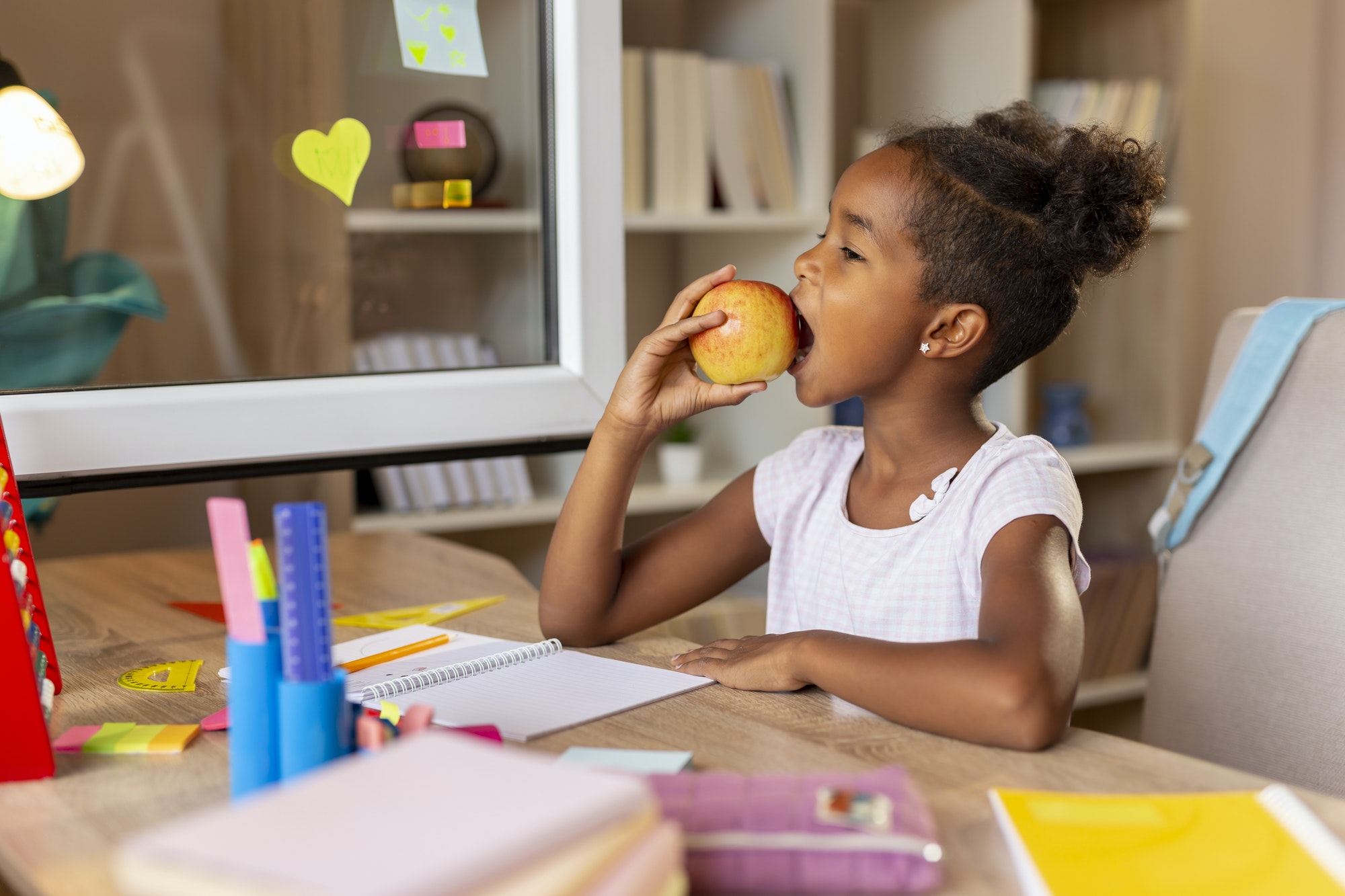 Schoolgirl eating an apple