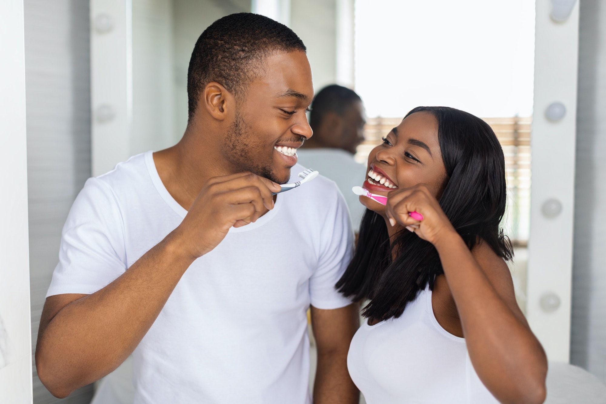 Romantic Black Couple Brushing Teeth And Smiling To Each Other In Bathroom