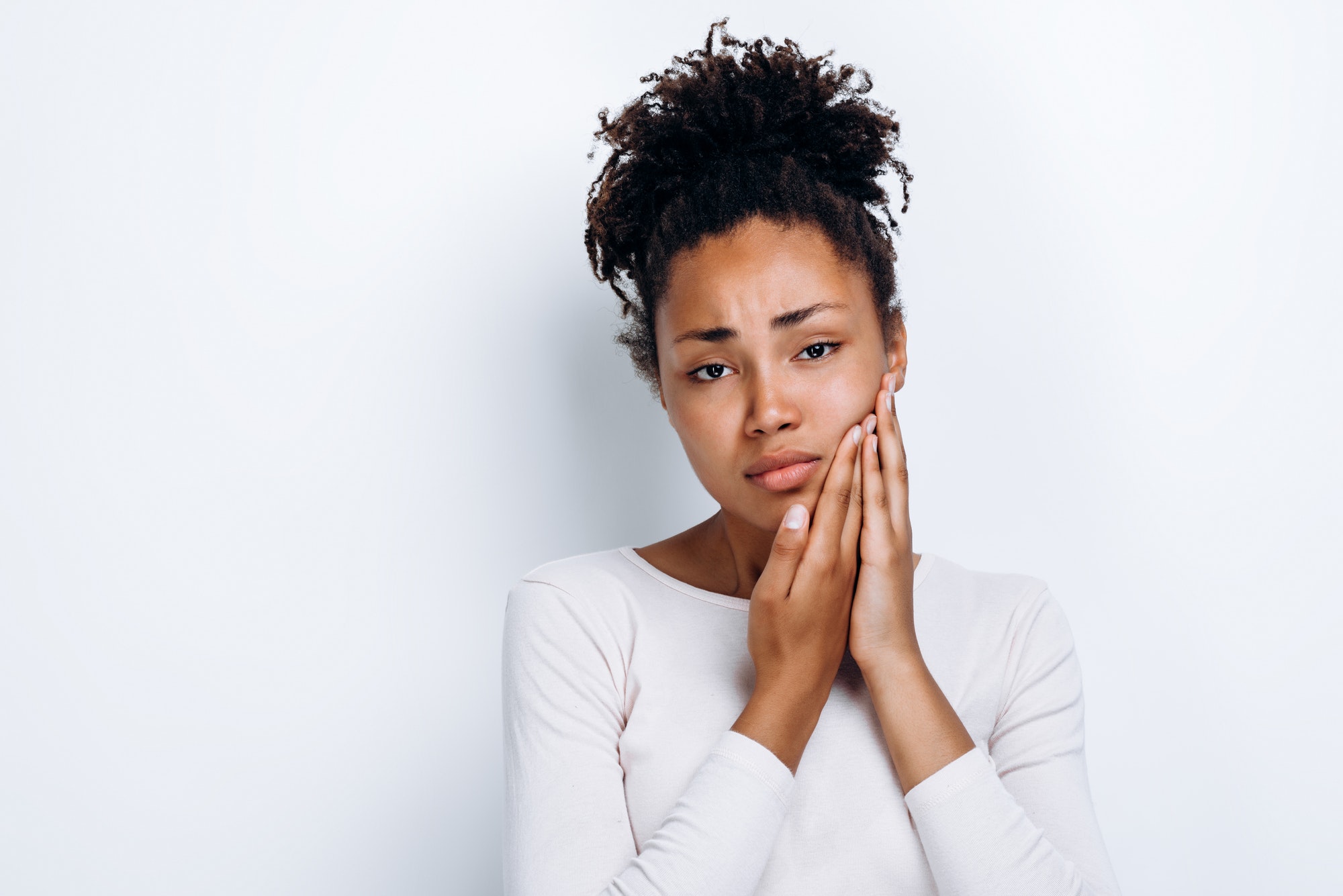 Young girl over isolated white background with toothache